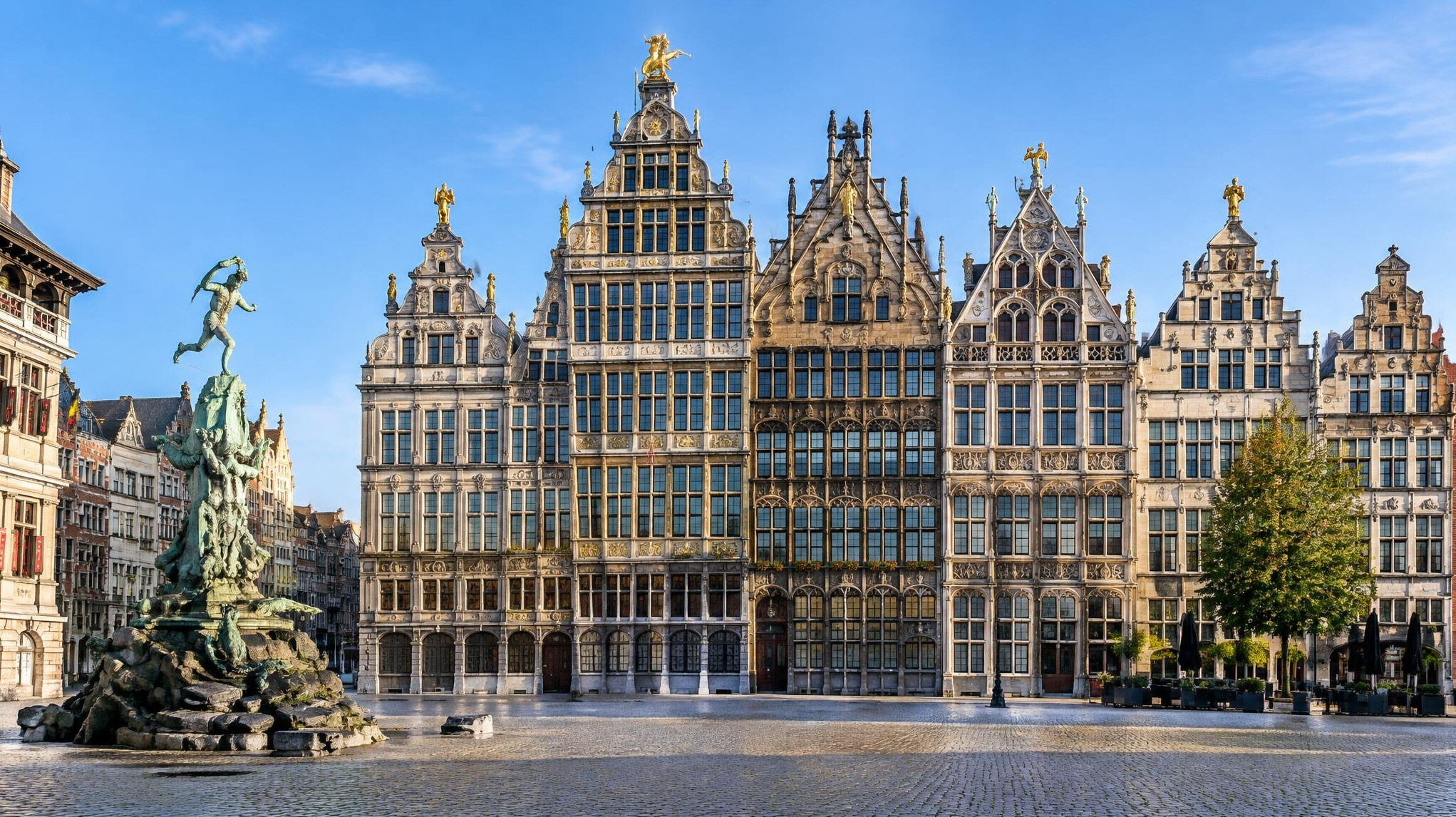 Historic stone guildhall facades on a European town square
