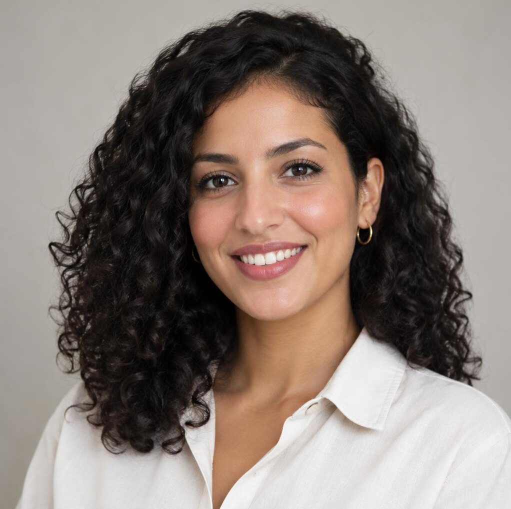 Portrait of a young woman with curly dark hair smiling